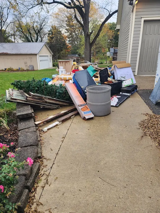 Dumpster being loaded with debris for Commercial Dumpster Rental in Sloan